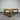 Wooden dining table against a corrugated metal wall