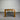Wooden dark stained dining table against a corrugated metal wall