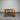 Wooden dark stained dining table against a corrugated metal wall