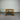 Wooden table against a corrugated metal wall