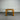 Wooden table against a corrugated metal wall.