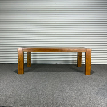 Wooden table against a corrugated metal wall