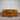 DFO, Wanaka, Wooden sideboard, 1800mm, with three drawers, two cupboards, Chestnut Pine finish, stained pine, DFO, NZ, against a corrugated metal wall. Wanaka collection