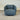 dark Blue swivel chair with a cushi on against a corrugated metal background