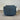 Blue textured swivel chair with a tag against a corrugated metal background