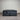 Front view of Backcare Premium mattress with matching base, showing grey quilted top, dark upholstered sides, caster wheels, and Backcare Premium branding on side panel against corrugated backdrop.
