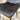 Gray cushioned chair seat with a blurred background