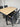 Close-up of Kartini table showing natural timber-look slats and anodised aluminium frame detail.