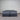 Workhorse King size mattress with matching base, front view showing grey quilted top, dark upholstered base with twin wheel legs and Hotel Mattress Co label against corrugated backdrop