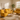 Yellow sofa set in a living room with a coffee table and decorative items.