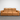 Brown leather sofa on a gray floor with a white wall background