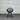 Black chair in front of a corrugated metal wall