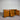 DFO, Clifton, Wooden sideboard, 1800mm, with three drawers, two cupboards, Chestnut Pine finish, stained pine, DFO, NZ, against a corrugated metal wall.