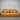 Tan Brown leather sofa against a metallic shutter background