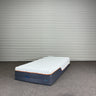 Mattress with I-REST FITNESS branding against a metallic wall.