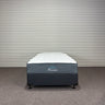 Mattress set with 'Pensavon' branding against a striped wall.