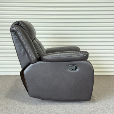 Gray recliner chair against a metallic background