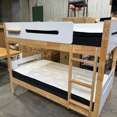Wooden bunk bed with white mattress in a showroom setting