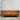 Brown leather sofa in a room with a plain wall.