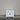 White cabinet with wooden top against a plain wall