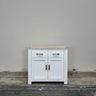 White cabinet with wooden top against a plain wall