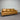 Brown leather sofa against a gray striped wall.