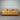 Brown leather sofa against a metallic shutter background