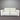 White sofa against a gray corrugated metal wall
