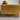 Mustard yellow sofa with black legs against a white wall.