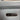 Close-up of a suitcase with charging ports and buttons on a light gray background