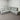 Gray sectional sofa in a room with white walls and carpet.