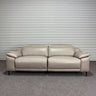 Beige leather sofa against a striped wall.