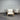 Outdoor furniture set with wooden frames and white cushions against a corrugated metal wall.