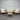 Outdoor furniture set with wooden chairs and table against a corrugated metal wall.
