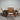 Wooden dining table with four chairs against a metal shutter background