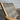 Beige wicker chair with a textured backrest against a metallic background