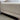 Beige sofa with wooden legs in a room setting