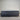 Workhorse LUX, King Single, Gray mattress on a gray floor with a striped wall background