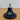 Black rubber foot with a metal screw on a wooden surface