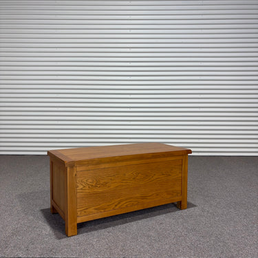 Wooden chest on a gray floor with a corrugated metal wall background