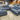 Blue sectional sofa with a price tag in a furniture store setting