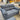 Gray sofa in a showroom with other furniture in the background