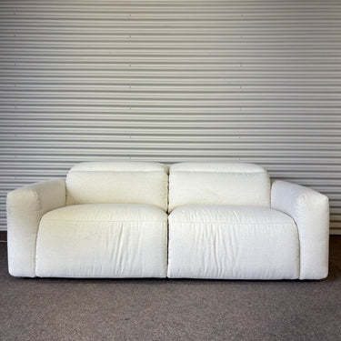 White sofa against a corrugated metal wall