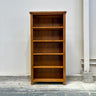 Wooden bookshelf against a white wall
