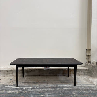 Black rectangular table against a plain white wall.