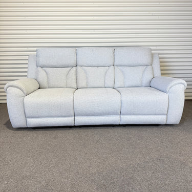 Gray sofa on a gray carpet with a white wall in the background