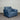 Blue armchair in a room with a corrugated metal wall.