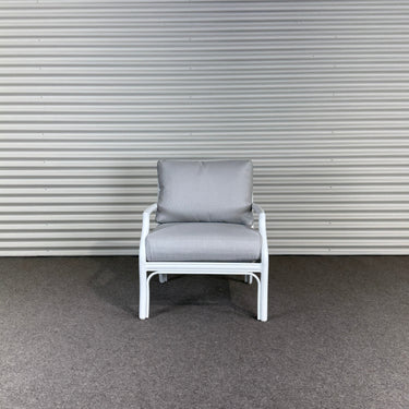 Gray chair against a corrugated metal wall
