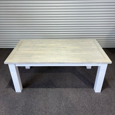 White wooden table against a metallic shutter background