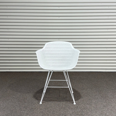 White chair against a corrugated metal wall